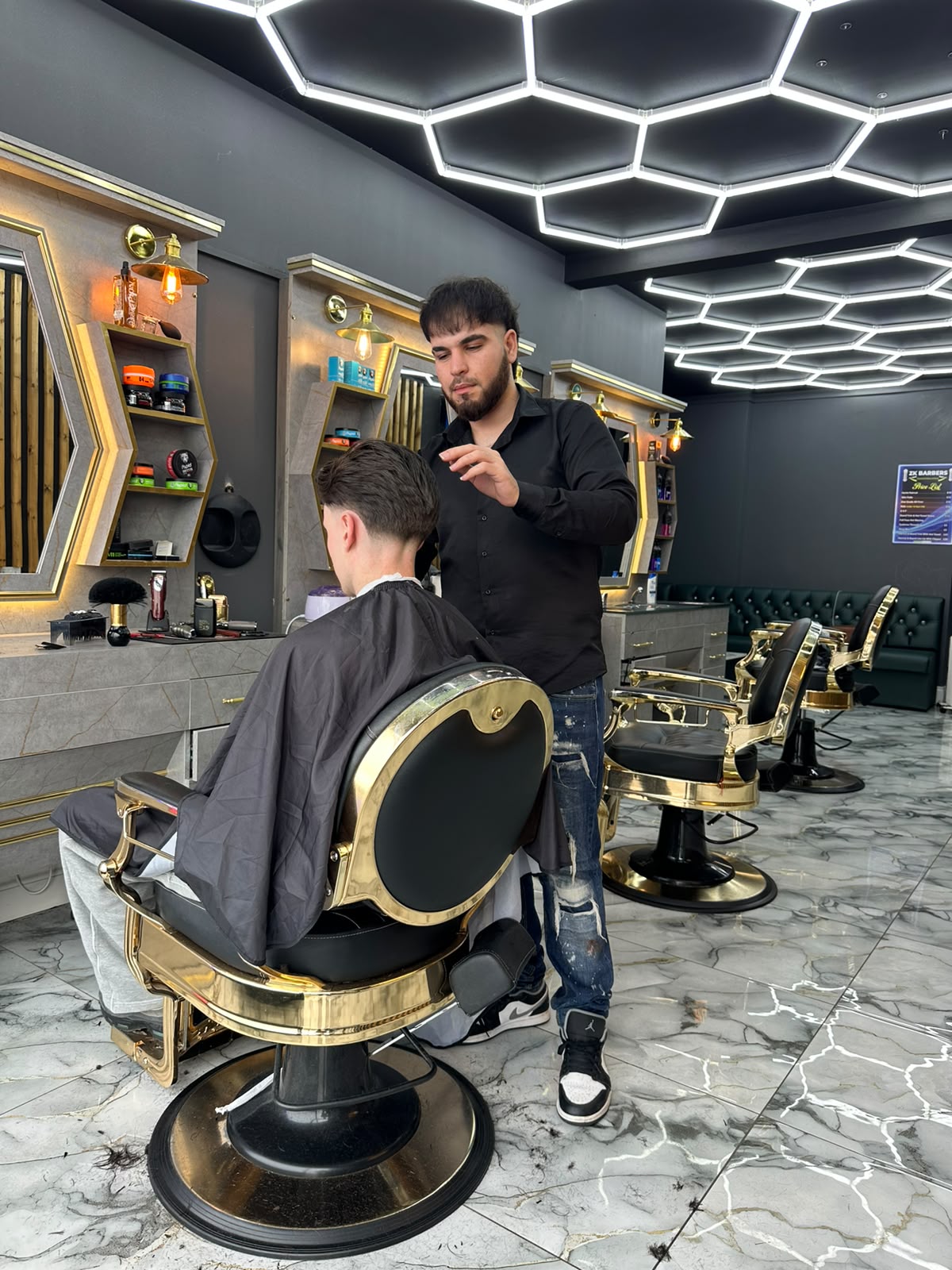 Barber styling a client inside ZK Barber's